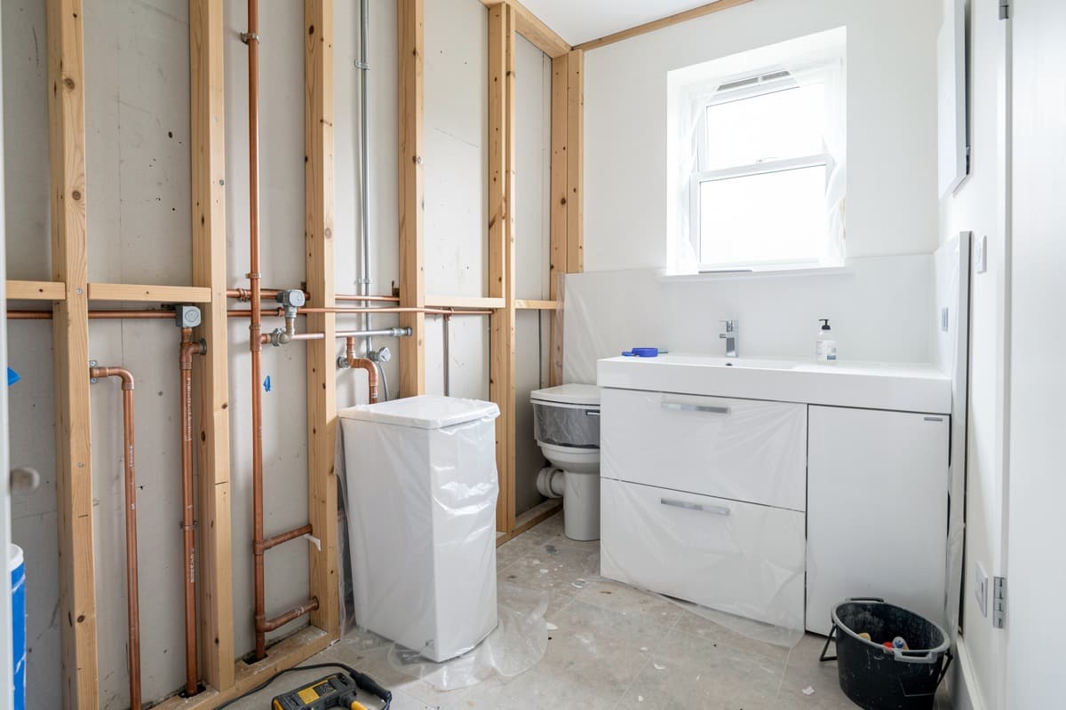Bathroom plumbing installation during refurbishment